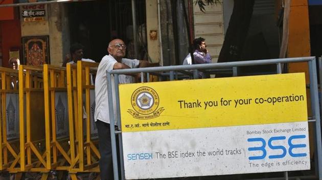 A man looks at a screen across the road displaying the Sensex on the facade of the Bombay Stock Exchange (BSE) building in Mumbai. (Reuters File photo) A man looks at a screen across the road displaying the Sensex on the facade of the Bombay Stock Exchange (BSE) building in Mumbai. (Reuters File photo)