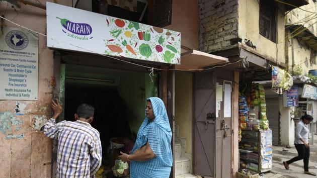 Narain Sabjiwala’s shop has a got signage for the first time --a simple design that has Narain written on a brinjal as a logo alongside other vegetables. Aanchal Baranwal, a Delhi-based multidisciplinary designer who did the branding said she realised during her conversations with the vendor that coriander and chilli is every customer’s demand, so she highlighted them in the background to show how they go with everything. (Burhaan Kinu / HT Photo) 