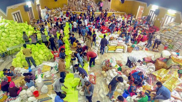 Volunteers segregate flood relief material at a distribution centre for Kerala floods, in Kochi on Sunday. Thomas Isaac said the revenue would be raised through various means, including cash and kind.(PTI)