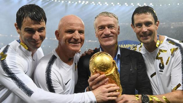 France's coach Didier Deschamps poses with the World Cup trophy.(AFP)