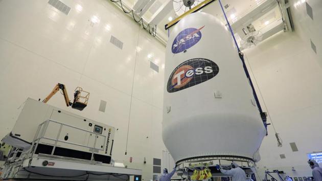 In this file photo taken on April 11, 2018 obtained from NASA, technicians assist as the SpaceX payload fairing containing the NASA’s Transiting Exoplanet Survey Satellite (TESS) is moved to a transporter, at NASA’s Kennedy Space Center, Florida. (AFP) In this file photo taken on April 11, 2018 obtained from NASA, technicians assist as the SpaceX payload fairing containing the NASA’s Transiting Exoplanet Survey Satellite (TESS) is moved to a transporter, at NASA’s Kennedy Space Center, Florida. (AFP)