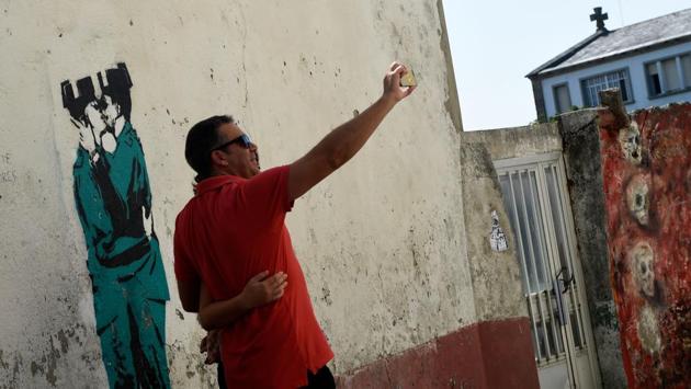 In April, a mural sporting Banksy’s signature appeared overnight, generating breathless excitement. Was this the famously anonymous graffiti star’s foray into Spain, coming to the rescue of the struggling town? Unfortunately not. Banksy’s website has since denied he was behind the image of two Guardia Civil police agents kissing, and the author’s identity remains a mystery. (Miguel Riopa / AFP) In April, a mural sporting Banksy’s signature appeared overnight, generating breathless excitement. Was this the famously anonymous graffiti star’s foray into Spain, coming to the rescue of the struggling town? Unfortunately not. Banksy’s website has since denied he was behind the image of two Guardia Civil police agents kissing, and the author’s identity remains a mystery. (Miguel Riopa / AFP)