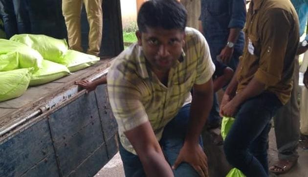 For eight days, Kannan Gopinathan worked at relief camps in flood-ravaged Kerala, spending two of those carrying large packages on his head while offloading relief material from trucks in the port city of Kochi.(HT Photo)