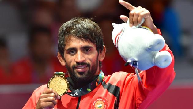 Bajrang Punia poses with his gold medal after winning in the men's freestyle wrestling (65kg) against Japan's Daichi Takatani at the Asian Games 2018.(PTI)