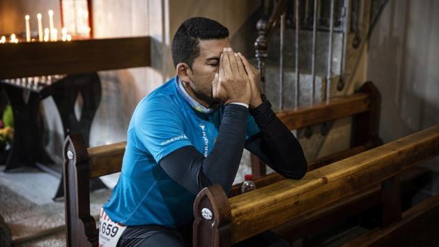 Rishman Lauret of France prays at the Saint Michel church in Chamonix, before the start of the race. The UTMB race route follows along the path of the Tour du Mont Blanc hiking trail, which usually takes hikers between 7 to 9 days. The entire trail is a loop around Mont Blanc. (Laurent Cipriani / AP) Rishman Lauret of France prays at the Saint Michel church in Chamonix, before the start of the race. The UTMB race route follows along the path of the Tour du Mont Blanc hiking trail, which usually takes hikers between 7 to 9 days. The entire trail is a loop around Mont Blanc. (Laurent Cipriani / AP)
