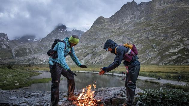 Competitors warm themselves up in front of a fire at the Combal lake. Last weekend, the weather was so cold and windy that runners had to deal with temperatures that felt like minus-10 degrees Celsius. (Laurent Cipriani / AP) Competitors warm themselves up in front of a fire at the Combal lake. Last weekend, the weather was so cold and windy that runners had to deal with temperatures that felt like minus-10 degrees Celsius. (Laurent Cipriani / AP)