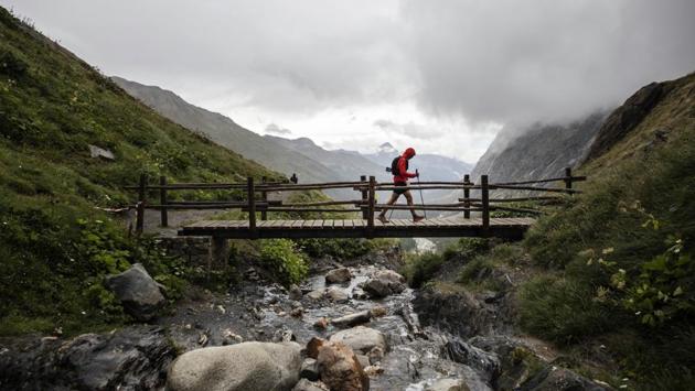 A competitor walks over a bridge on the Grand Col Ferret. “Each person manages the emotions of experiencing one of the most incredible adventures of their lives and, at the same time, the fear of knowing if they will be capable of getting to the end,” three-time winner Kilian Jornet wrote in his book “Run or Die.” (Laurent Cipriani / AP) A competitor walks over a bridge on the Grand Col Ferret. “Each person manages the emotions of experiencing one of the most incredible adventures of their lives and, at the same time, the fear of knowing if they will be capable of getting to the end,” three-time winner Kilian Jornet wrote in his book “Run or Die.” (Laurent Cipriani / AP)