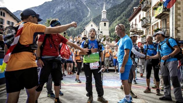 Abdennour Benmammar of France, the last finisher, is congratulated after crossing the finish line at the end of the Ultra-Trail of Mont-Blanc. Benmammar crossed the finish line more than 26 hours after Thevenard. (Laurent Cipriani / AP) Abdennour Benmammar of France, the last finisher, is congratulated after crossing the finish line at the end of the Ultra-Trail of Mont-Blanc. Benmammar crossed the finish line more than 26 hours after Thevenard. (Laurent Cipriani / AP)