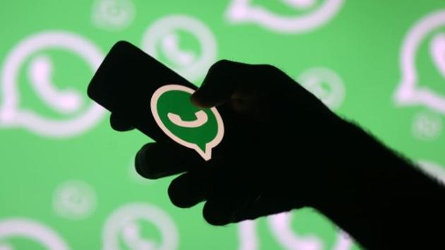 A man poses with a smartphone in front of displayed Whatsapp logo in this illustration September 14, 2017. REUTERS/Dado Ruvic(Reuters File Photo)