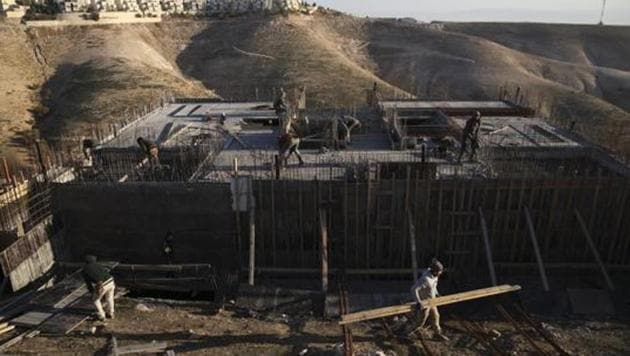 Palestinian laborers work at a construction site in the Israeli settlement of Maale Adumim, near Jerusalem.(AP File Photo)