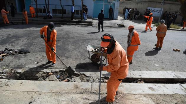 Afghan municipality workers clean the street near the site of a suicide attack, after a blast that targeted wrestlers during a training session at the Maiwand Club, in Kabul on September 6, 2018. (AFP) Afghan municipality workers clean the street near the site of a suicide attack, after a blast that targeted wrestlers during a training session at the Maiwand Club, in Kabul on September 6, 2018. (AFP)