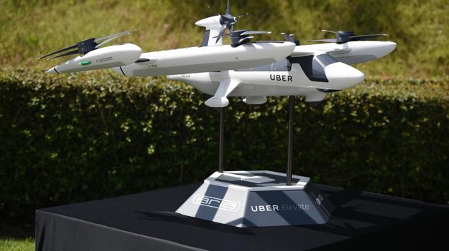 A model of Uber's electric vertical take-off and landing vehicle concept (eVTOL) flying taxi is displayed at the second annual Uber Elevate Summit, on May 8, 2018 at the Skirball Center in Los Angeles, California. Uber introduced it's electric powered "flying taxi" vertical take-off and landing concept aircraft at the event, which showcases prototypes for UberAir's fleet of airborne taxis. (AFP Photo) A model of Uber's electric vertical take-off and landing vehicle concept (eVTOL) flying taxi is displayed at the second annual Uber Elevate Summit, on May 8, 2018 at the Skirball Center in Los Angeles, California. Uber introduced it's electric powered "flying taxi" vertical take-off and landing concept aircraft at the event, which showcases prototypes for UberAir's fleet of airborne taxis. (AFP Photo)