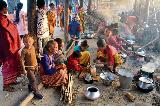 Life must go on: Violence-affected villagers prepare food at a relief camp at Gossaigaon, in the Kokrajhar district of northeastern Assam state in December 2014.(AFP) Life must go on: Violence-affected villagers prepare food at a relief camp at Gossaigaon, in the Kokrajhar district of northeastern Assam state in December 2014.(AFP)