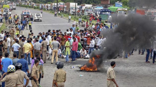 Several upper caste organisation activists raise slogans and burn tyres during Bharat Bandh protest called over SC/ST Amendment Act, in Varanasi, Thursday. (PTI Photo) Several upper caste organisation activists raise slogans and burn tyres during Bharat Bandh protest called over SC/ST Amendment Act, in Varanasi, Thursday. (PTI Photo)