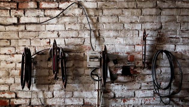 Parts of a powerloom machine are seen inside a weaving factory, which was shut earlier this year. Some of his customers and suppliers could not afford to hire accountants to navigate a system which has been amended more than 200 times already, while others struggled to cope with delays in tax returns caused by glitches in the centralised software. (Adnan Abidi / REUTERS)