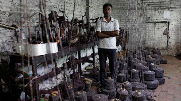 Ram Pratap, who lost his job as a powerloom operator, at the factory where he worked. A survey by the All India Trade Union Congress (AITUC) in July found that a fifth of India’s 63 million small businesses – contributing 32% to the economy and employing 111 million people - faced a 20% fall in profits since GST rollout, and had to sack hundreds of thousands of workers. (Adnan Abidi / REUTERS)