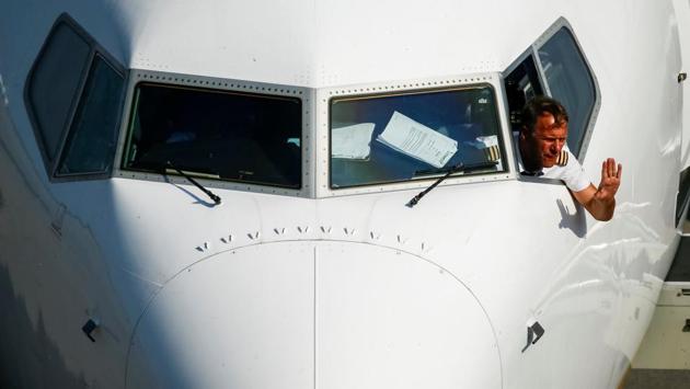 A Ryanair pilot waves from the cockpit of the Boeing 737-8AS during an event of the Irish low-cost airline to present the first flight to Berlin from Boryspil International Airport outside Kiev, Ukraine. (Gleb Garanich / REUTERS) A Ryanair pilot waves from the cockpit of the Boeing 737-8AS during an event of the Irish low-cost airline to present the first flight to Berlin from Boryspil International Airport outside Kiev, Ukraine. (Gleb Garanich / REUTERS)