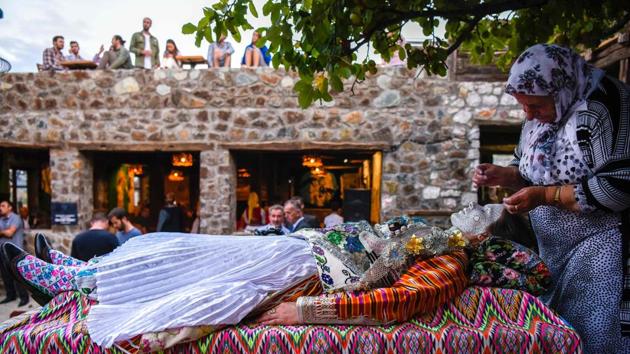 Kosovar woman Sheqerie Buqaj lays on her back as she receives a traditional face painting while presenting the traditional wedding of Bosnian women from Zhupa region, during the “Etno Fest” festival in the village of Kukaj. (Armend Nimani / AFP) Kosovar woman Sheqerie Buqaj lays on her back as she receives a traditional face painting while presenting the traditional wedding of Bosnian women from Zhupa region, during the “Etno Fest” festival in the village of Kukaj. (Armend Nimani / AFP)