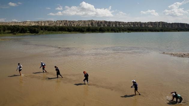 State media articles have called efforts to use sporting events to attract tourists a success, saying they have brought 10,000 visitors to the lake so far this year, double the total for 2017. The National Sports Bureau recognised Longyangxia as a “sports and leisure speciality town” in 2017, Qinghai’s only town on the bureau’s list of 100. (Thomas Peter / REUTERS) State media articles have called efforts to use sporting events to attract tourists a success, saying they have brought 10,000 visitors to the lake so far this year, double the total for 2017. The National Sports Bureau recognised Longyangxia as a “sports and leisure speciality town” in 2017, Qinghai’s only town on the bureau’s list of 100. (Thomas Peter / REUTERS)