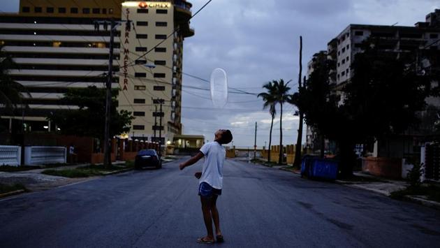 Arturo Perez, 14, plays on the street with a condom in Havana, Cuba. (Alexandre Meneghini / REUTERS) Arturo Perez, 14, plays on the street with a condom in Havana, Cuba. (Alexandre Meneghini / REUTERS)