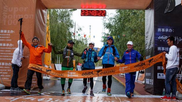 Runners cross the ultra-marathon finish line. While the government and companies anticipate gains from an adventure tourism boom in the country, participants are itching for opportunities. Some, like Professor He say they are drawn by scenic locations, others are like Dou who said she could still live if she couldn’t run, but just wouldn’t be happy. (Thomas Peter / REUTERS) Runners cross the ultra-marathon finish line. While the government and companies anticipate gains from an adventure tourism boom in the country, participants are itching for opportunities. Some, like Professor He say they are drawn by scenic locations, others are like Dou who said she could still live if she couldn’t run, but just wouldn’t be happy. (Thomas Peter / REUTERS)