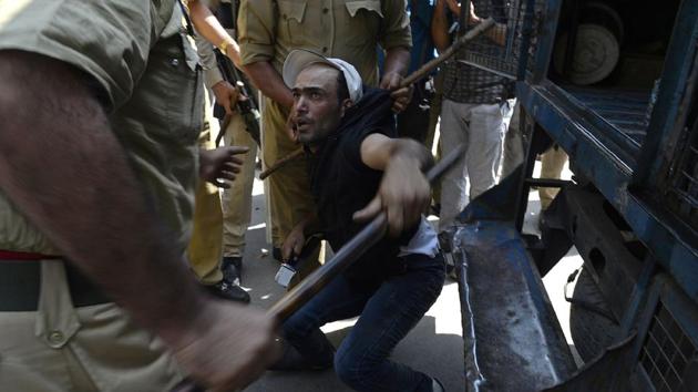 A Kashmiri government teacher shouts anti government slogans as police try to detain him during a protest against the government in Srinagar, Jammu and Kashmir. Police used water cannon and detained dozens of government teachers as they demanded hikes in salary and regularisations of their job. (Tauseef Mustafa / AFP) A Kashmiri government teacher shouts anti government slogans as police try to detain him during a protest against the government in Srinagar, Jammu and Kashmir. Police used water cannon and detained dozens of government teachers as they demanded hikes in salary and regularisations of their job. (Tauseef Mustafa / AFP)