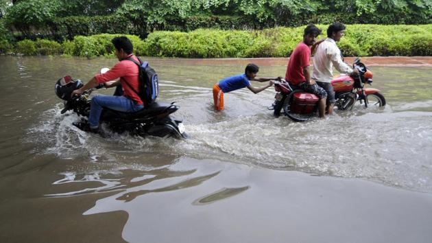 Commuters pass through a water logged street at sector 44 underpass, following heavy rains in Noida, Uttar Pradesh. (Sunil Ghosh / HT Photo) Commuters pass through a water logged street at sector 44 underpass, following heavy rains in Noida, Uttar Pradesh. (Sunil Ghosh / HT Photo)
