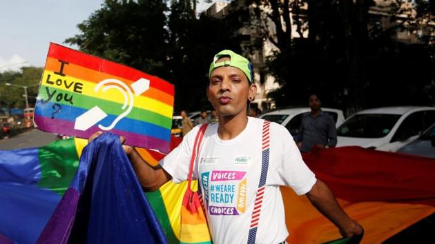 A supporter of the lesbian, gay, bisexual and transgender (LGBT) community holds a placard as he celebrates after the Supreme Court's verdict of decriminalizing gay sex and revocation of the Section 377 law, during a march in Mumbai.(REUTERS)
