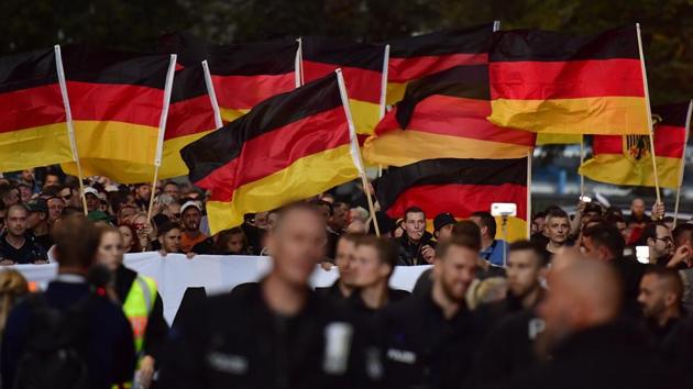 People hold national flags during a march organised by the right-wing populist "Pro Chemnitz" movement, the far-right Alternative for Germany (AfD) party and the anti-Islam Pegida movement, on September 7, 2018 in Chemnitz. (AFP File Photo) People hold national flags during a march organised by the right-wing populist "Pro Chemnitz" movement, the far-right Alternative for Germany (AfD) party and the anti-Islam Pegida movement, on September 7, 2018 in Chemnitz. (AFP File Photo)