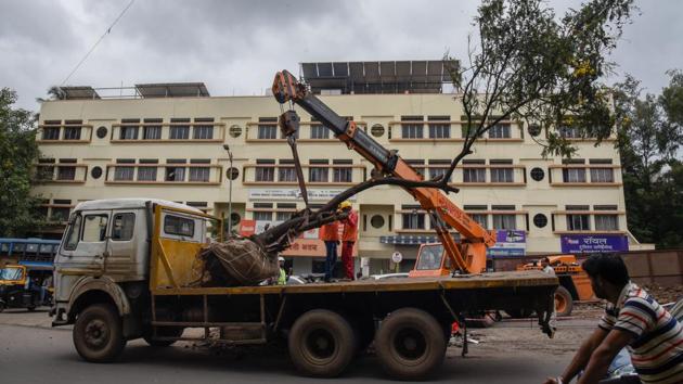 As metro work progresses in the city, workers from the Maha-Metro transport a tree from Paud road near MIT college to a suitable location, on Tuesday. (SANKET WANKHADE/HT PHOTO) As metro work progresses in the city, workers from the Maha-Metro transport a tree from Paud road near MIT college to a suitable location, on Tuesday. (SANKET WANKHADE/HT PHOTO)