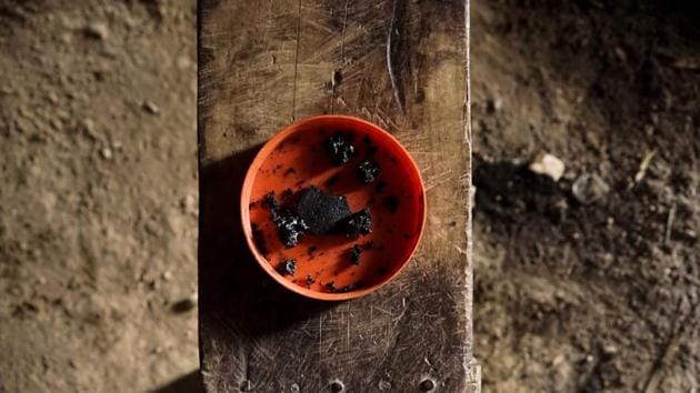 Pieces of opium resin are seen in a plastic bowl. In 2015 around 5,700 hectares of Laos were estimated to be under opium cultivation -- more than triple the amount in 2007. Several major seizures of raw opium and heroin this year in Vietnam couriered by Hmong villagers has renewed scrutiny on the relationship between opium and Laos’ most marginalised people. (Aidan Jones / AFP)