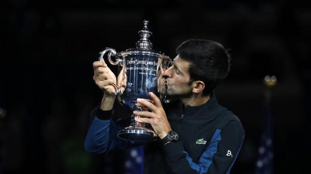 Novak Djokovic poses with the championship trophy after winning his men's Singles finals match against Juan Martin del Potro of Argentina at the US Open.(AFP)