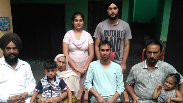 Kamal Manjinder Singh (centre) with his family in Gurdaspur on Sunday. (hT Photo) Kamal Manjinder Singh (centre) with his family in Gurdaspur on Sunday. (hT Photo)