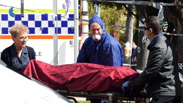 Forensic police (C) and other officials remove a dead body from the crime site in the suburb of Australia's western city of Perth on September 10, 2018. (AFP) Forensic police (C) and other officials remove a dead body from the crime site in the suburb of Australia's western city of Perth on September 10, 2018. (AFP)