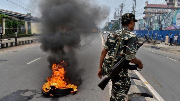 A security personnel walks past a burning tyre during a protest against fuel price hike and depreciation of the rupee in Guwahati. Tens of people were detained in Assam from multiple districts after they tried to block roads and highways to enforce the shutdown, a senior police official said. However, the Bandh has paralysed normal life as buses and taxis kept off the roads. (PTI) A security personnel walks past a burning tyre during a protest against fuel price hike and depreciation of the rupee in Guwahati. Tens of people were detained in Assam from multiple districts after they tried to block roads and highways to enforce the shutdown, a senior police official said. However, the Bandh has paralysed normal life as buses and taxis kept off the roads. (PTI)