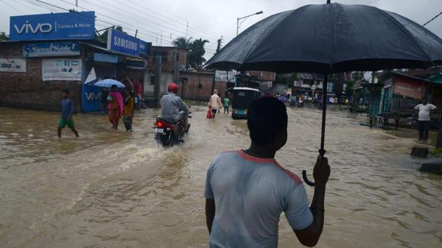 People make their way through floodwaters from the overflowing Panchanai River in Siliguri on September 10, 2018. (AFP) People make their way through floodwaters from the overflowing Panchanai River in Siliguri on September 10, 2018. (AFP)