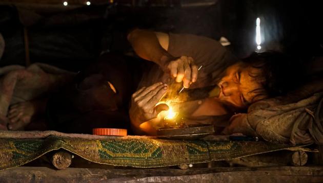 In a hut on the top of mountain in northern Laos, Vo Pali gets high on opium, a sap extracted from poppies grown illegally by the poor hill tribes. “It has damaged my life. I have no income. But I get sick without it,” the 60-year-old ethnic Hmong villager said in a barely audible rasp of his 30-year habit. The Hmong have grown and smoked opium as a medicine -- and as recreation -- for generations. (Aidan Jones / AFP)