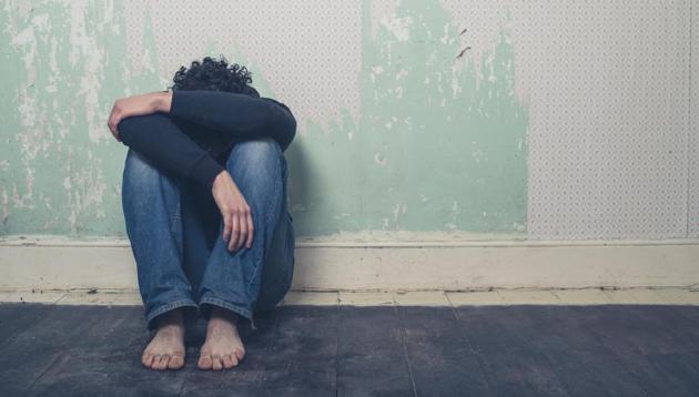 A sad and depressed young man is sitting on the floor in an empty room.(Getty Images/iStockphoto)