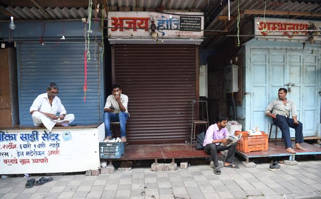 Shopkeepers outside closed shops at a Mumbai market during the nationwide general strike called by the Opposition over rising fuel prices (AFP) Shopkeepers outside closed shops at a Mumbai market during the nationwide general strike called by the Opposition over rising fuel prices (AFP)