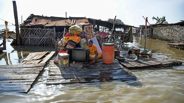 A woman secures her belongings after the water level of river Ganga rose creating a flood-like situation at Daraganj, in Allahabad. According to reports made available by Flood Control Room, the level of Ganga in Phaphamau was registered at 81.44 meters against the danger mark of 84.73 meters in Allahabad. (PTI) A woman secures her belongings after the water level of river Ganga rose creating a flood-like situation at Daraganj, in Allahabad. According to reports made available by Flood Control Room, the level of Ganga in Phaphamau was registered at 81.44 meters against the danger mark of 84.73 meters in Allahabad. (PTI)