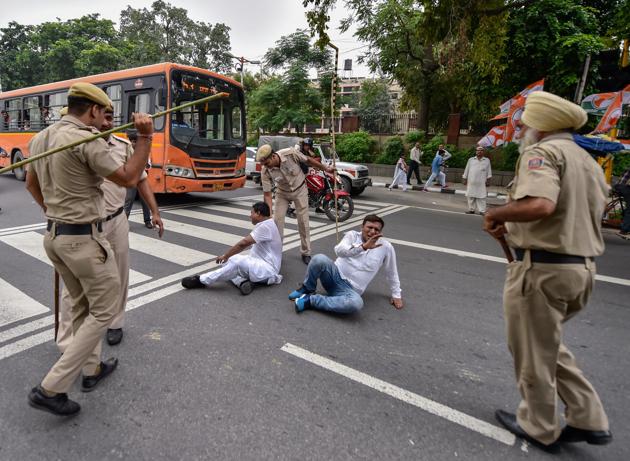 Policemen lathi charge Congress workers taking part in the Bharat Bandh protests in New Delhi on Monday. (PTI) Policemen lathi charge Congress workers taking part in the Bharat Bandh protests in New Delhi on Monday. (PTI)