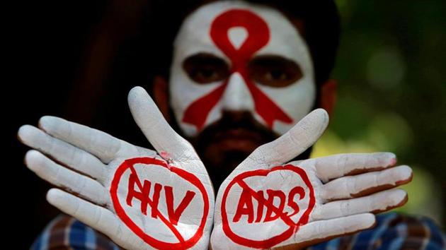 A student displays his hands painted with messages as he poses during an HIV/AIDS awareness campaign to mark the International AIDS Candlelight Memorial, in Chandigarh on May 20.(REUTERS)