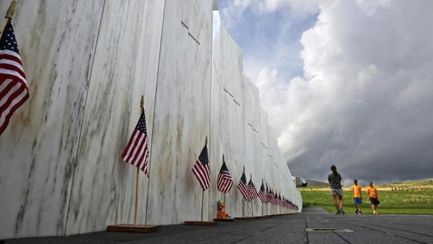 In this May 31, 2018 file photo, visitors to the Flight 93 National Memorial pause at the Wall of Names honouring 40 passengers and crew members of United Flight 93 killed when the hijacked jet crashed at the site during the 9/11 terrorist attacks, near Shanksville, Pennsylvania.(AP File Photo)