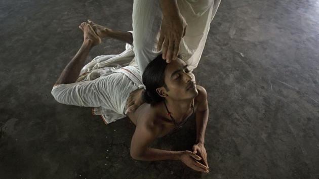 A teacher helps a young monk practice Mati Akhora which is the foundation of the Sattriya dance. The dance is generally performed in the namghar or prayer hall of the Satra and its themes center around Radha and Krishna-- sometimes other Vishnu avatars such as Rama and Sita. (Anupam Nath / AP)