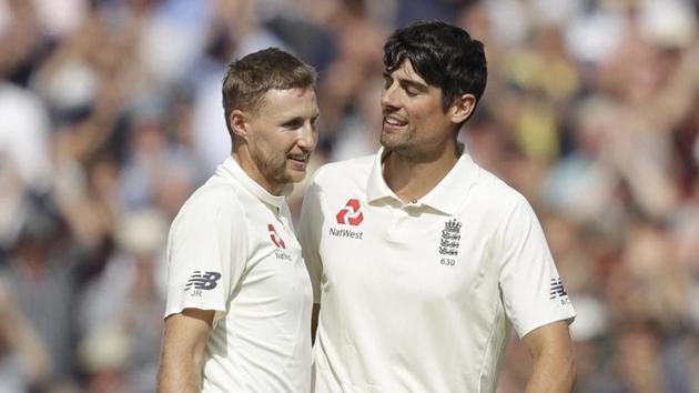 England's Alastair Cook, right, in his last ever batting innings before retiring from test cricket, celebrates reaching his century with his batting partner England's Joe Root. (AP)