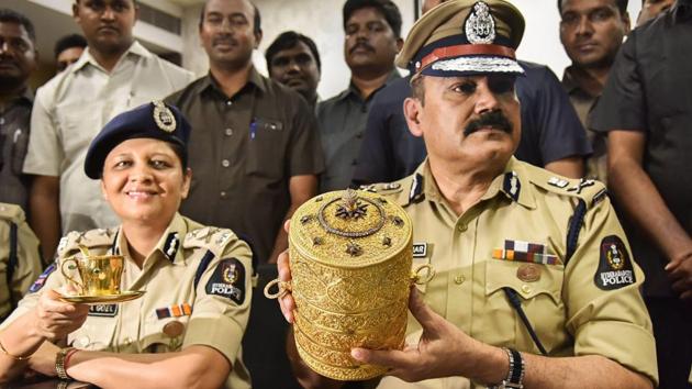 Police Commissioner Anjani Kumar along with a senior police officer shows to media the three-tier golden tiffin box and a golden cup after their recovery, in Hyderabad, Tuesday, Sep 11, 2018. (PTI) Police Commissioner Anjani Kumar along with a senior police officer shows to media the three-tier golden tiffin box and a golden cup after their recovery, in Hyderabad, Tuesday, Sep 11, 2018. (PTI)