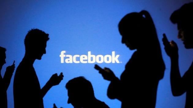 People are silhouetted as they pose with mobile devices in front of a screen projected with a Facebook logo. (REUTERS) People are silhouetted as they pose with mobile devices in front of a screen projected with a Facebook logo. (REUTERS)