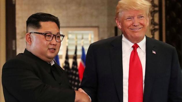 US President Donald Trump and North Korea's leader Kim Jong Un shake hands after signing documents during a summit at the Capella Hotel on the resort island of Sentosa, Singapore, June 12, 2018.(Reuters File Photo)