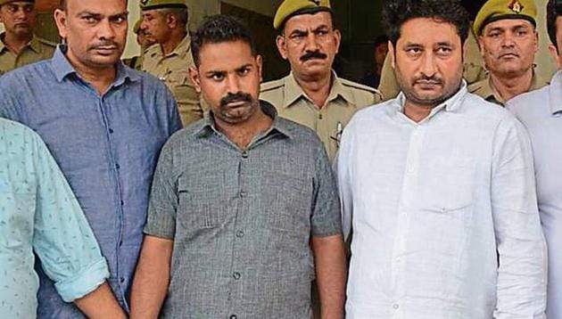 The three men reached Modinagar police station with nine illegal arms and 100 live cartridges.(Sakib Ali /HT Photo) The three men reached Modinagar police station with nine illegal arms and 100 live cartridges.(Sakib Ali /HT Photo)
