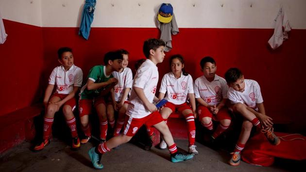 Candelaria Cabrera (3rd R), sits with her teammates before a match against the Alumni football team. “Cande,” as she is known by friends and family, is the only girl playing in a children’s football league in the southern party of Santa Fe province, birthplace of stars including Lionel Messi, Gabriel Batistuta and Jorge Valdano. (Natacha Pisarenko / AP) Candelaria Cabrera (3rd R), sits with her teammates before a match against the Alumni football team. “Cande,” as she is known by friends and family, is the only girl playing in a children’s football league in the southern party of Santa Fe province, birthplace of stars including Lionel Messi, Gabriel Batistuta and Jorge Valdano. (Natacha Pisarenko / AP)